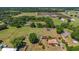 Wide aerial shot highlighting a home on a large lot with outbuildings amidst rural landscape at 4615 Keene Rd, Plant City, FL 33565