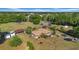 Aerial view of the property featuring a single-story home with an tile roof and surrounding trees at 4615 Keene Rd, Plant City, FL 33565