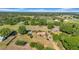 Aerial view of a single-story home with surrounding trees and fields at 4615 Keene Rd, Plant City, FL 33565