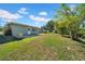 Large backyard with green grass, trees, and a sunny exposure at 4615 Keene Rd, Plant City, FL 33565