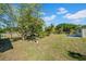 Lush backyard featuring mature trees, green grass, and room for entertainment at 4615 Keene Rd, Plant City, FL 33565