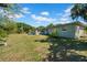 Spacious backyard perfect for outdoor activities, featuring a well-maintained lawn and peaceful surroundings at 4615 Keene Rd, Plant City, FL 33565