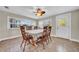 Sunlit dining area features a ceiling fan, windows and an exterior door at 4615 Keene Rd, Plant City, FL 33565