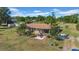 Inviting single-story home with mature trees and a cozy front patio for relaxing and entertaining at 4615 Keene Rd, Plant City, FL 33565
