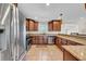 Modern kitchen with stainless steel appliances, wood cabinets, and granite countertops, designed for convenience at 4615 Keene Rd, Plant City, FL 33565