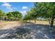 A sandy landscape on a well-lit land, surrounded by lush trees at 4615 Keene Rd, Plant City, FL 33565