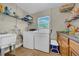 Functional laundry room with a utility sink and storage cabinets, making chores more efficient at 4615 Keene Rd, Plant City, FL 33565