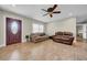 Spacious living room with tile flooring and ample natural light, providing a comfortable gathering space at 4615 Keene Rd, Plant City, FL 33565