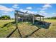 Run-down shed on a grassy area with a blue sky overhead at 4615 Keene Rd, Plant City, FL 33565