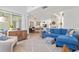 Open concept living room with modern decor and a view into kitchen at 4859 Napoli Ne Ct # 4859, St Petersburg, FL 33703