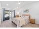 Relaxing main bedroom with sliding glass doors to backyard, neutral tones, and soft carpet at 4859 Napoli Ne Ct # 4859, St Petersburg, FL 33703