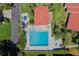 Aerial view of the community pool area with lounge chairs, mature trees, and spa at 4859 Napoli Ne Ct # 4859, St Petersburg, FL 33703