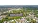 Expansive aerial view of the neighborhood showcasing a pond and lush greenery throughout the community at 5832 Sussex Dr, Tampa, FL 33615