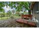 Backyard featuring a wood fence, lots of trees, and a wooden deck at 5832 Sussex Dr, Tampa, FL 33615