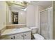 Bathroom featuring a shower, toilet, single sink vanity, and mirrored medicine cabinet at 5832 Sussex Dr, Tampa, FL 33615