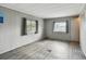Neutral bedroom with hardwood floors, dual windows, and ample natural light at 5832 Sussex Dr, Tampa, FL 33615