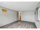 Neutral bedroom featuring hardwood floors, a window, and generous space at 5832 Sussex Dr, Tampa, FL 33615