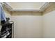 This walk-in closet features a rack for shoes and other shelving at 5832 Sussex Dr, Tampa, FL 33615
