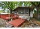 Outside view of home featuring a screened porch and spacious deck at 5832 Sussex Dr, Tampa, FL 33615