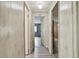Hallway with wooden walls and ceiling and wood-style floors provide access to rooms at 5832 Sussex Dr, Tampa, FL 33615