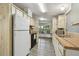 Vintage-style kitchen featuring wood countertops, white cabinets, and a view to the adjacent sitting area at 5832 Sussex Dr, Tampa, FL 33615