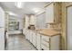 Traditional kitchen design with cream-colored cabinets, wood-look countertops, and modern laminate flooring at 5832 Sussex Dr, Tampa, FL 33615