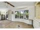 Inviting sunroom with a ceiling fan, natural light, laminate floors and sliding glass doors to the outside at 5832 Sussex Dr, Tampa, FL 33615