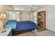 Well-lit main bedroom with wood floors, a ceiling fan, and an ensuite bathroom at 5832 Sussex Dr, Tampa, FL 33615
