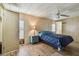 Cozy main bedroom featuring a ceiling fan, hardwood floors, and two windows at 5832 Sussex Dr, Tampa, FL 33615