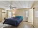 Comfortable main bedroom offering a ceiling fan, windows, and access to an ensuite bathroom at 5832 Sussex Dr, Tampa, FL 33615