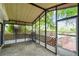 View of the cozy screened porch leading out to the deck and yard at 5832 Sussex Dr, Tampa, FL 33615
