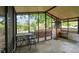 View of the cozy screened porch leading out to the yard and garden at 5832 Sussex Dr, Tampa, FL 33615
