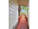 A red walkway provides an entryway to the exterior of the house, showcasing the natural surroundings at 5832 Sussex Dr, Tampa, FL 33615