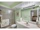 Well-maintained bathroom with glass shower door, toilet, and a large mirror at 6021 Bahia Del Mar Cir # 137, St Petersburg, FL 33715