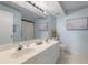 Bright bathroom featuring a dual sink vanity, a toilet, and a large mirror at 6021 Bahia Del Mar Cir # 137, St Petersburg, FL 33715