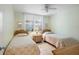 Bright bedroom with two twin beds, neutral walls and tiled floors at 6021 Bahia Del Mar Cir # 137, St Petersburg, FL 33715