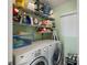 Functional laundry room featuring a washer, dryer, and ample shelving at 6021 Bahia Del Mar Cir # 137, St Petersburg, FL 33715