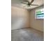 Simple bedroom with carpet and a ceiling fan, providing a blank canvas for personalization and rest at 6420 N Thatcher Ave, Tampa, FL 33614