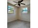 Bright bedroom with ceiling fan, carpet flooring, and natural light creates a relaxing and airy atmosphere at 6420 N Thatcher Ave, Tampa, FL 33614