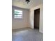 Cozy bedroom with carpeted floors, closet, and a window, offering comfort and practical storage at 6420 N Thatcher Ave, Tampa, FL 33614