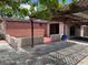 Backyard patio and covered area with patterned tile and access to the residence and gated parking at 6420 N Thatcher Ave, Tampa, FL 33614