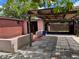 Backyard patio and covered area with patterned tile and access to the residence and gated parking at 6420 N Thatcher Ave, Tampa, FL 33614