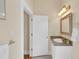 Neutral-toned bathroom with a single sink vanity, lots of light, and a patterned tile floor at 7701 N Dartmouth Ave, Tampa, FL 33604