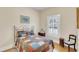 Cozy bedroom featuring a quilt-covered bed, hardwood floors, and natural light from window at 7701 N Dartmouth Ave, Tampa, FL 33604
