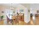 Open-concept dining room with hardwood floors, a dining table, and views into the living room at 7701 N Dartmouth Ave, Tampa, FL 33604