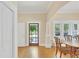 View of dining room featuring a wooden table, hardwood floors and natural light from large windows at 7701 N Dartmouth Ave, Tampa, FL 33604