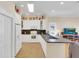 Well-lit kitchen featuring white cabinets, a breakfast bar, and an open layout into the adjacent living area at 7701 N Dartmouth Ave, Tampa, FL 33604