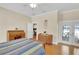 Large main bedroom with writing desk, dresser, and access to private porch at 7701 N Dartmouth Ave, Tampa, FL 33604