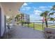 Spacious balcony featuring seating and views of the waterfront and landscaped grounds at 8020 Sailboat Key S Blvd # 101, St Pete Beach, FL 33707