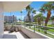Balcony with views of nearby buildings and palm trees at 8020 Sailboat Key S Blvd # 101, St Pete Beach, FL 33707